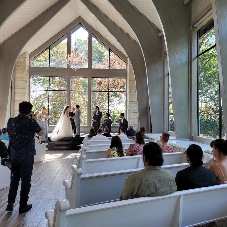 wedding ceremony in chapel with large windows