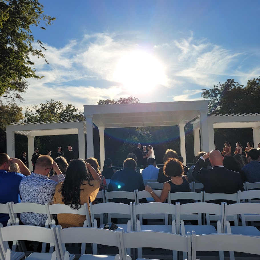 outdoor wedding ceremony under white pergola