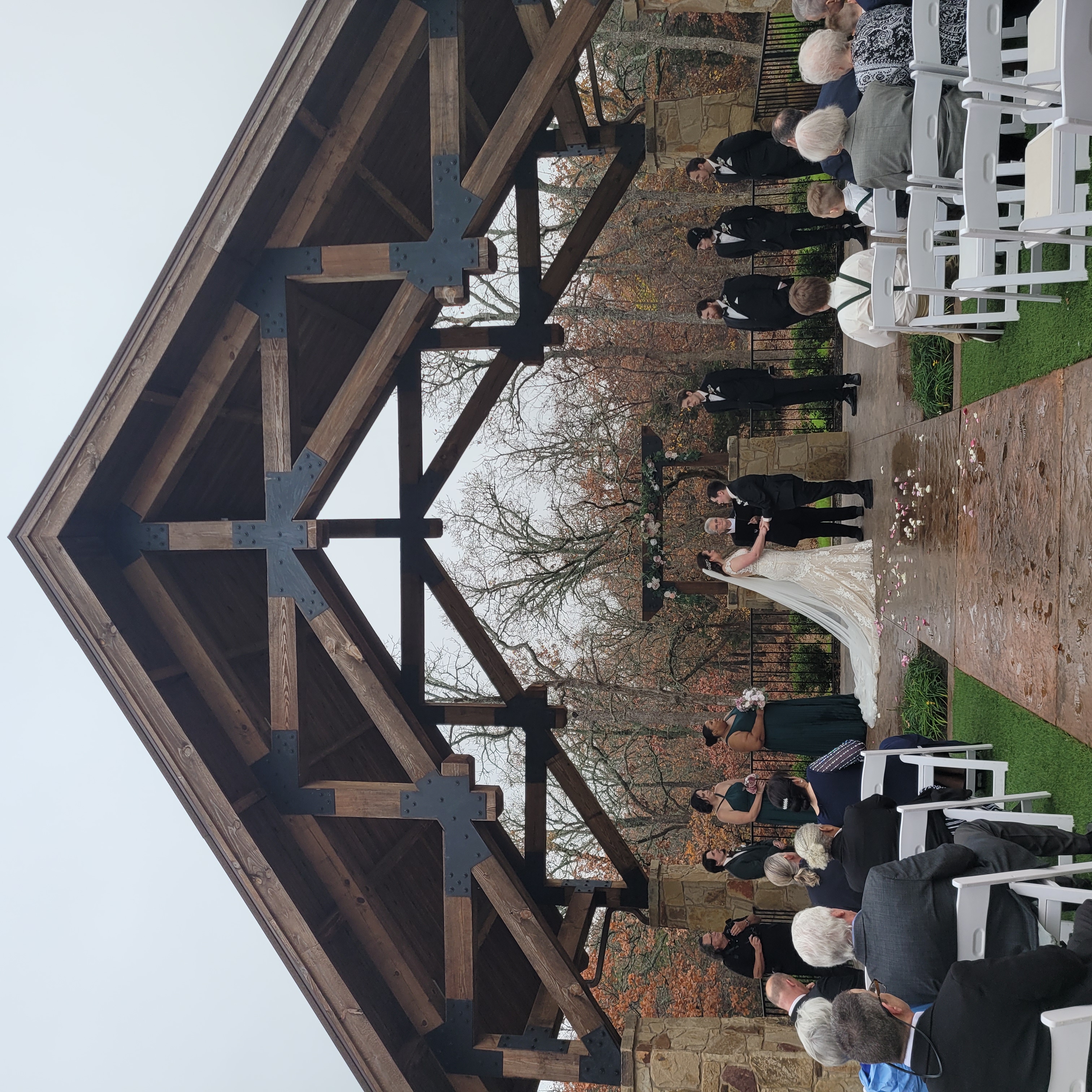 wedding under large wooden pavilion