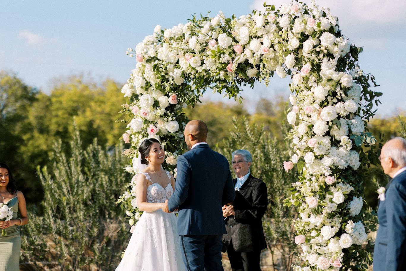 bride smiling at groom during wedding ceremony