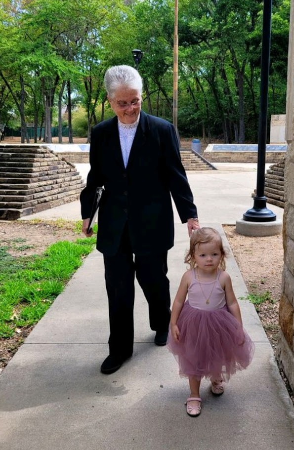 wedding officiant walking with flower girl