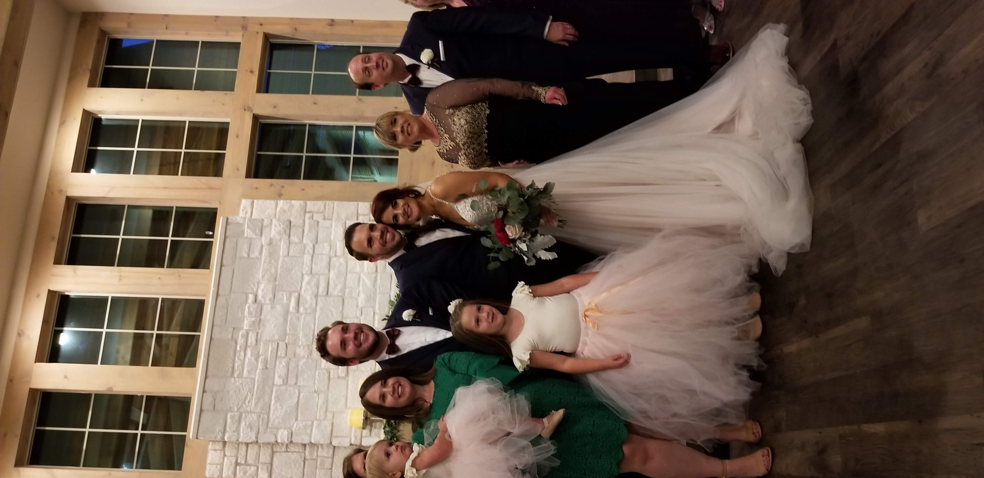 couple smiling with wedding party