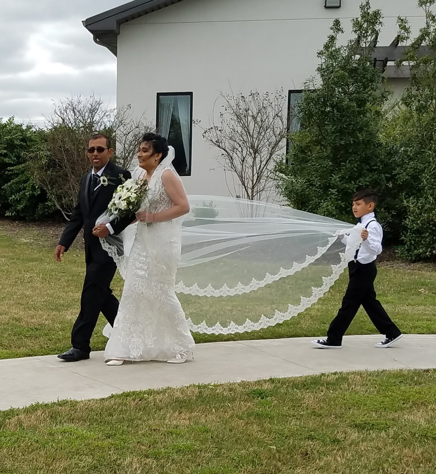 ring bearer holding bride's veil