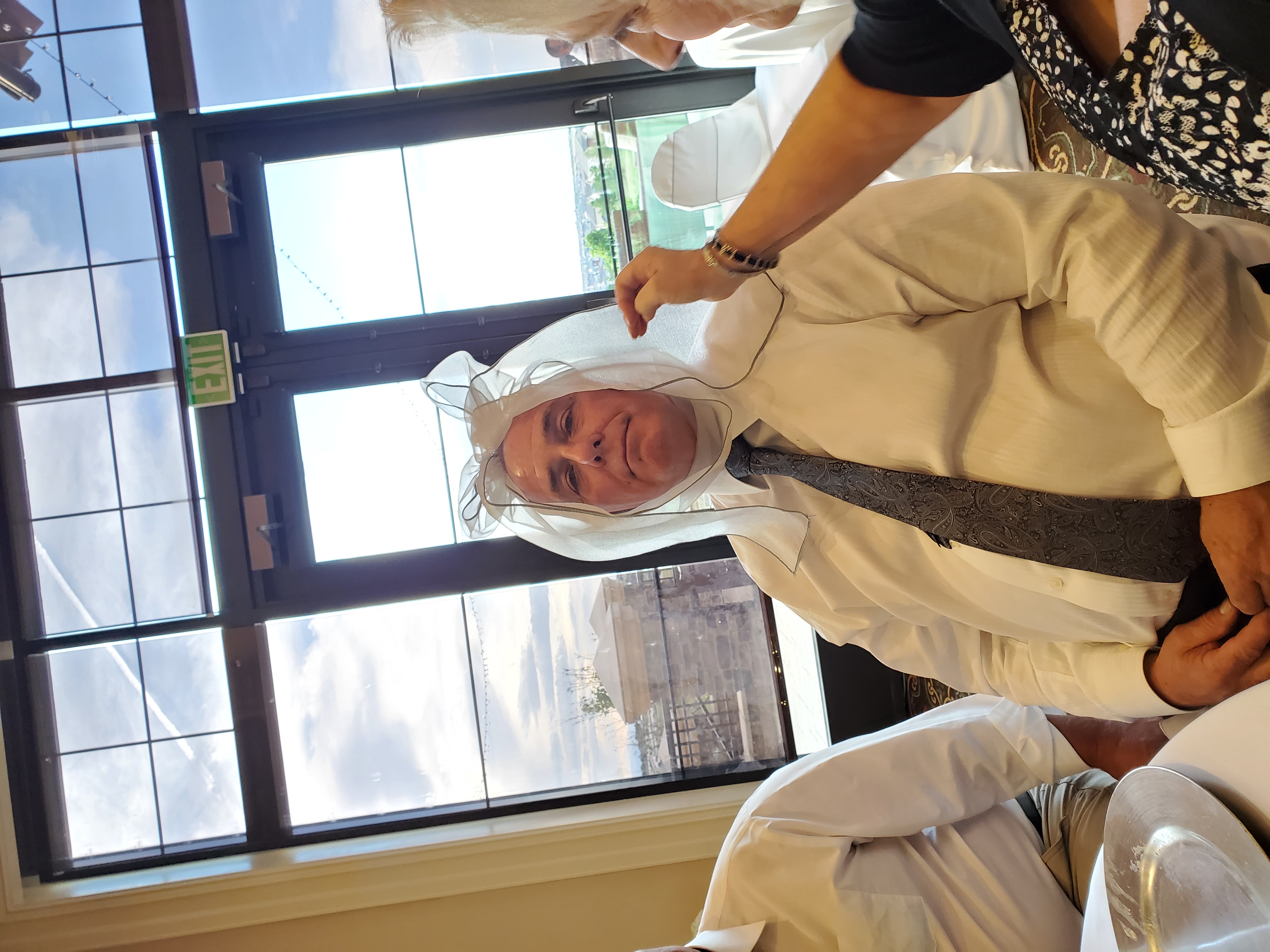 wedding guest with silly bow on his head