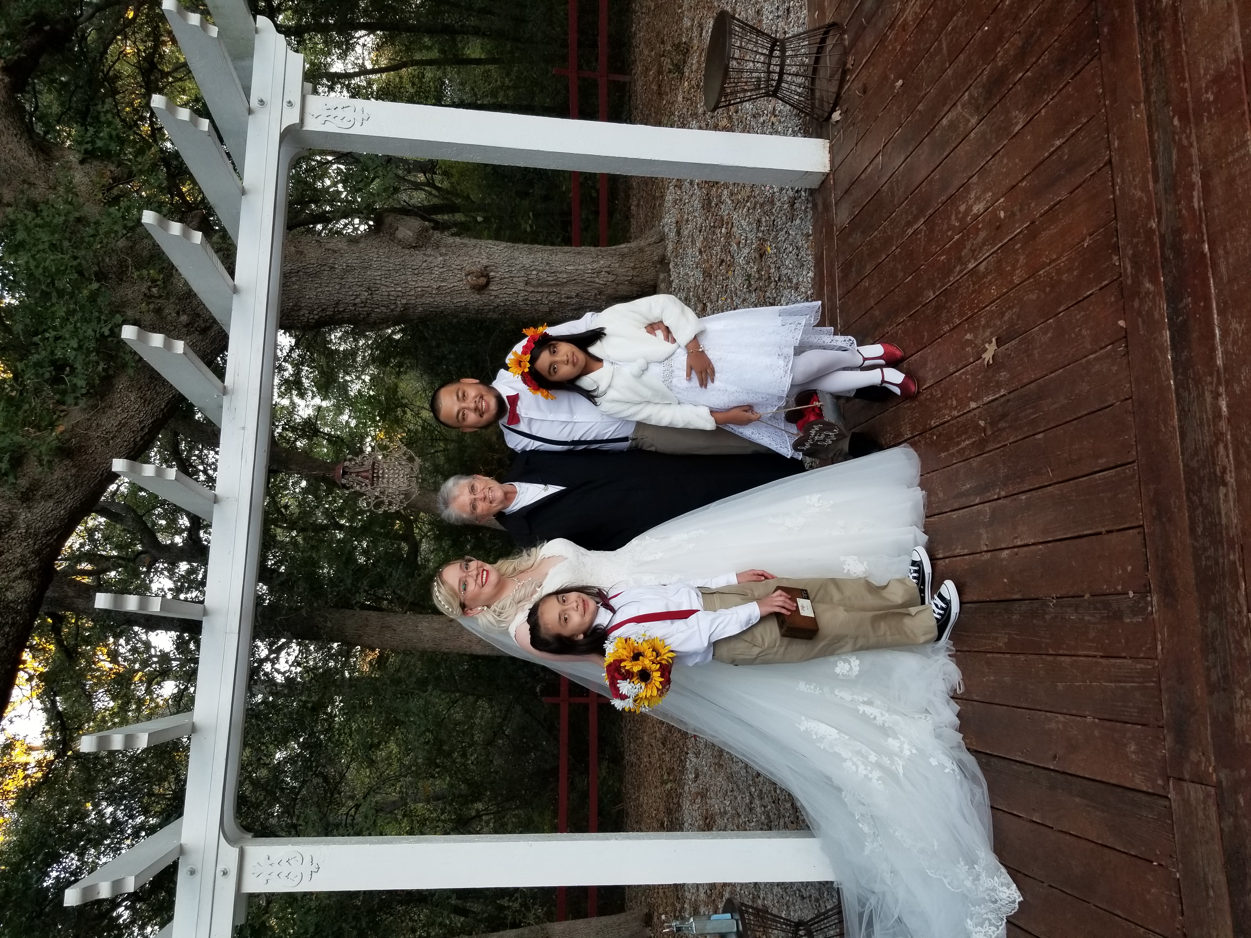 bride and groom with officiant at backyard wedding